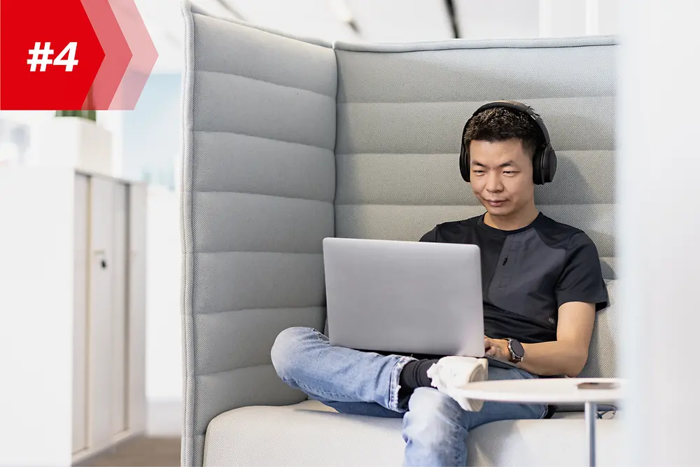Henkel-medarbejder Hao, Head of Mobile App Factory, med hovedtelefoner og sin bærbare computer